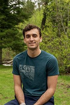 Young man in front of green background